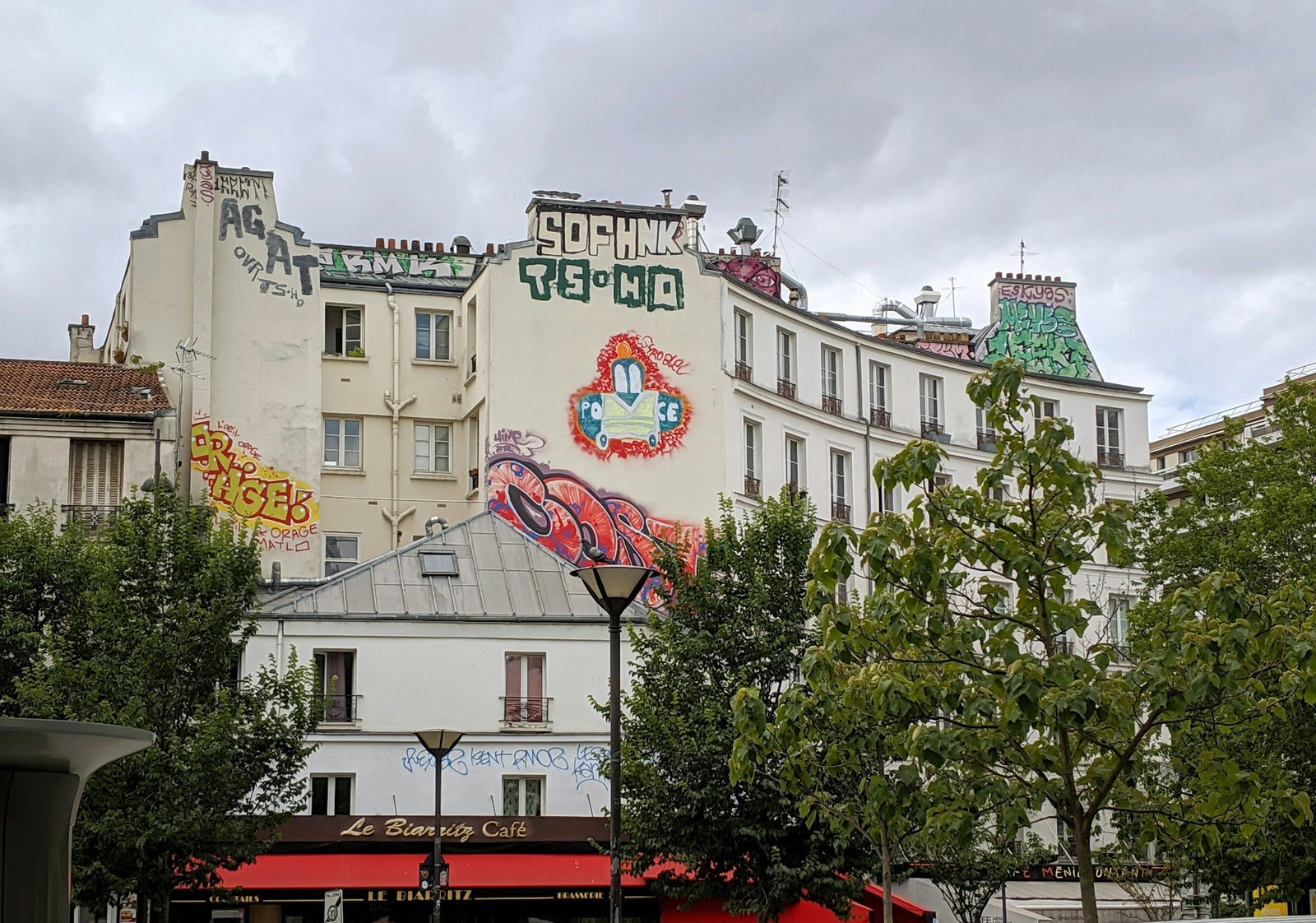 street artists painting a new mural on rue Dénoyez